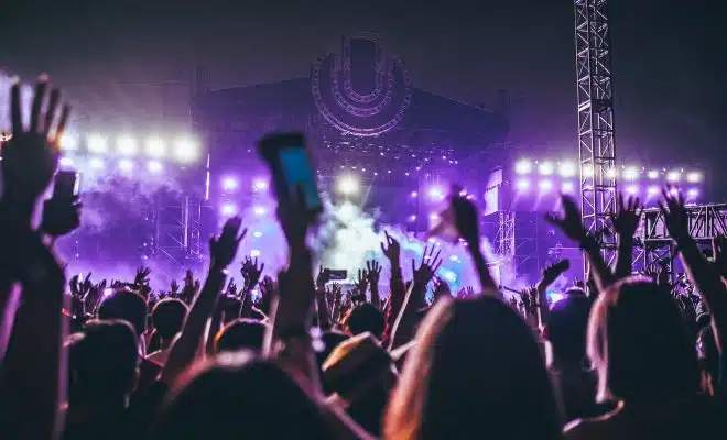 group of people raising there hands in concert